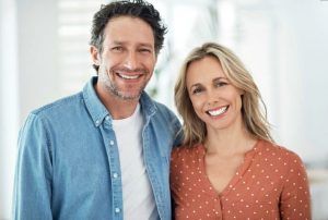 stock image of a man and woman smiling for blog about the benefits of professional teeth whitening in Charlotte